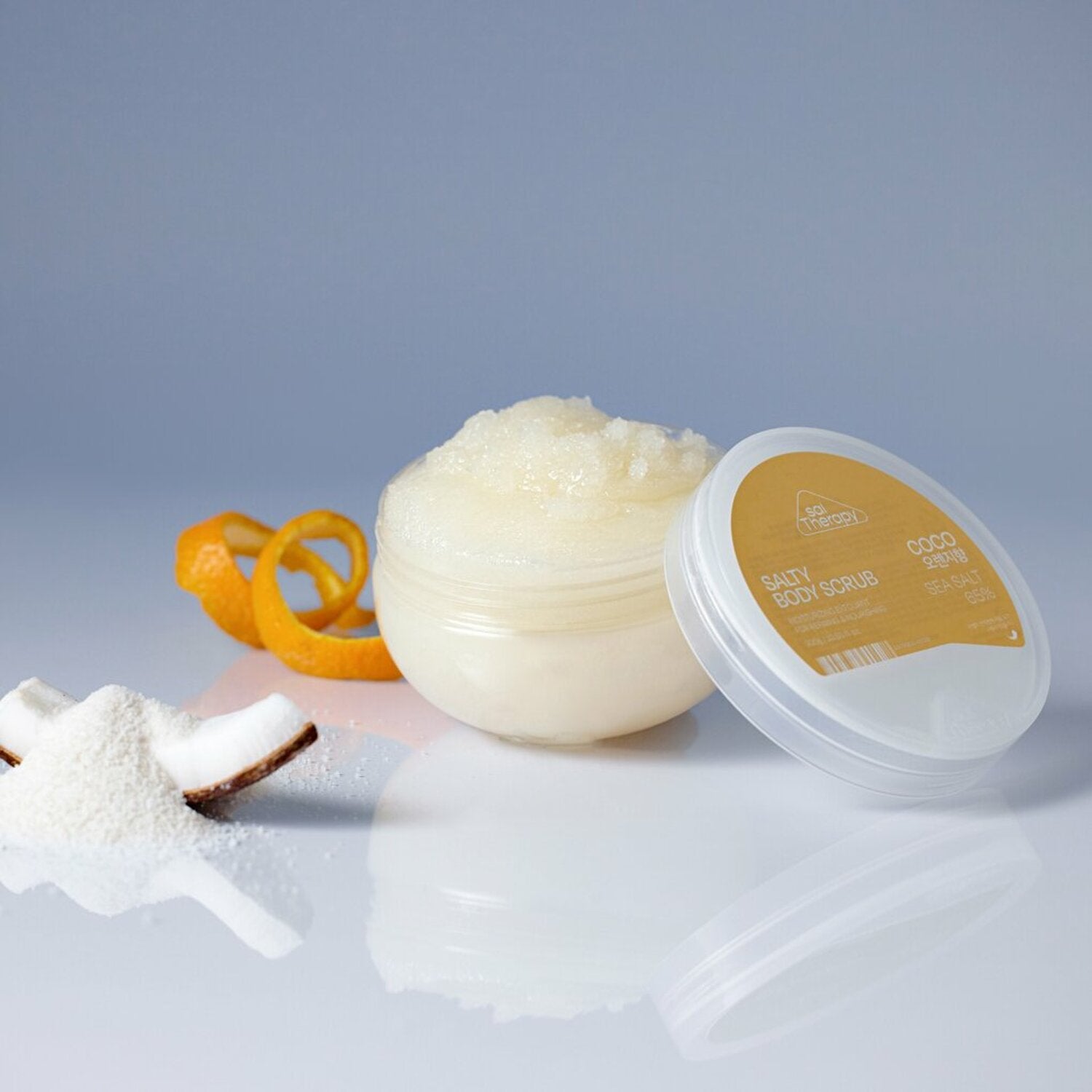  300g jar of SalTherapy Salty Body Scrub with pink label and sea salt crystals.